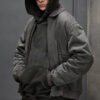 Model wearing a washed mobility bomber jacket over a hoodie