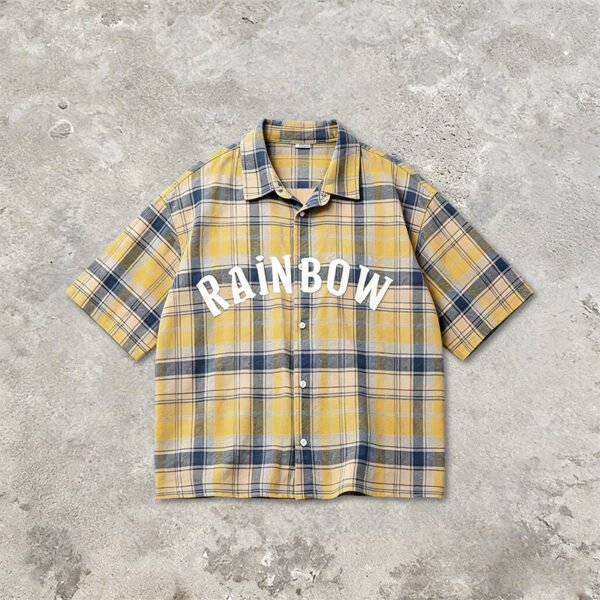 Yellow and blue plaid short sleeve shirt with white 'RAINBOW' text