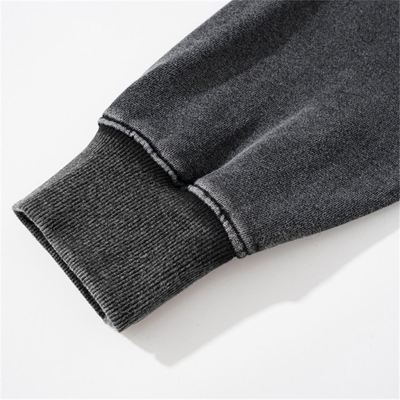 Close-up of a dark gray washed pullover hoodie cuff