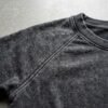 Close-up of a dark grey washed raglan cropped t-shirt.