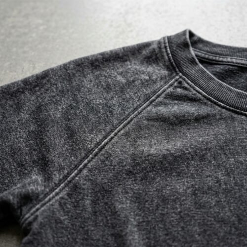 Close-up of a dark grey washed raglan cropped t-shirt.