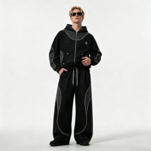 Man wearing a black washed rivet zip hoodie and wide leg pants