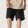 Man wearing washed spliced panel cotton shorts