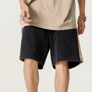 Man wearing washed spliced panel cotton shorts