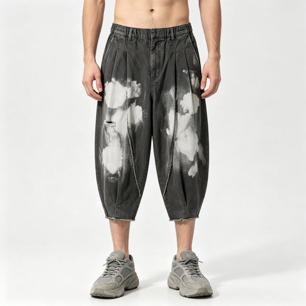 Washed dark gray tapered cropped pants with cloud print and distressed details.