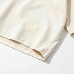 Close-up of a plain, washed cream-colored t-shirt