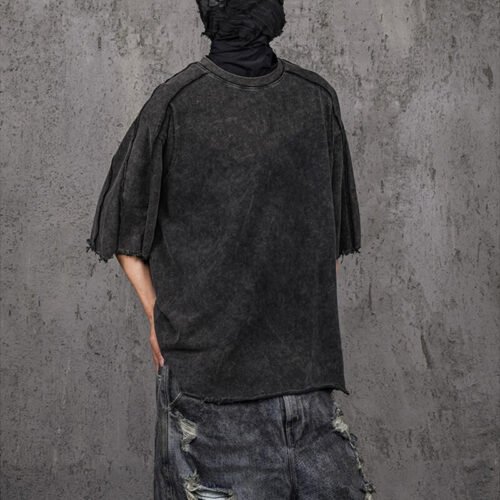 Dark grey washed oversized t-shirt with a distressed vintage look and raw edges.