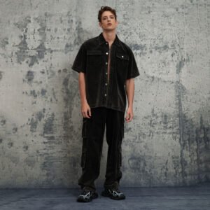 Man wearing a dark washed short-sleeve button-up shirt and cargo pants