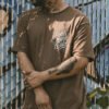 Brown t-shirt with 'Foos gone wild' script graphic on the chest