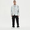 Man wearing a custom iridescent textured panel-print streetwear jacket