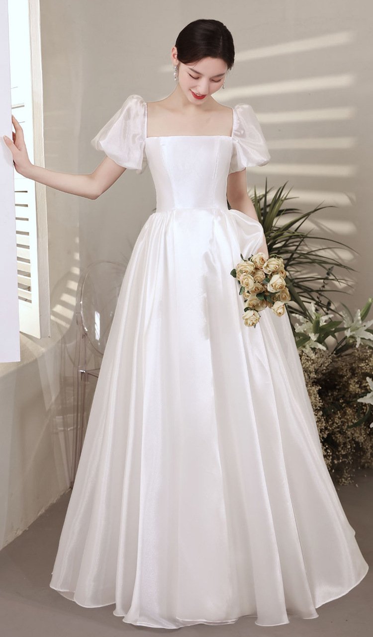 White satin wedding dress with puff sleeves and a square neckline