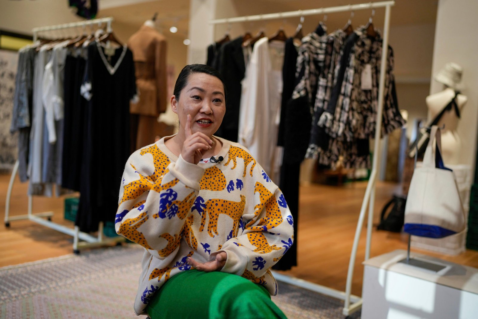 Woman wearing a cheetah print sweatshirt in a clothing store
