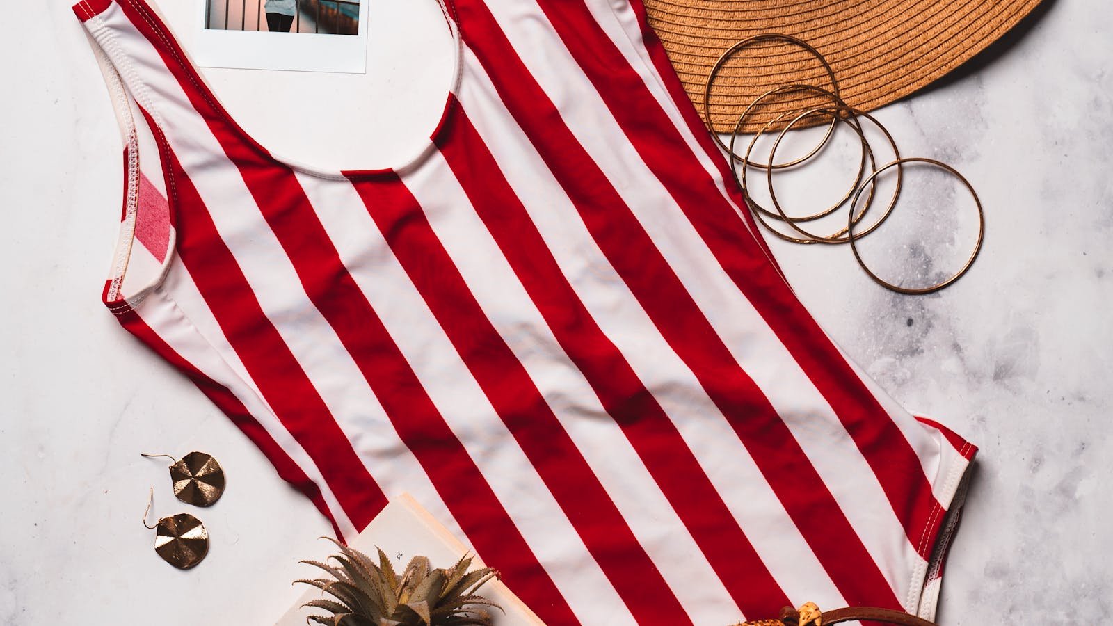 Red and white striped one-piece swimsuit with accessories