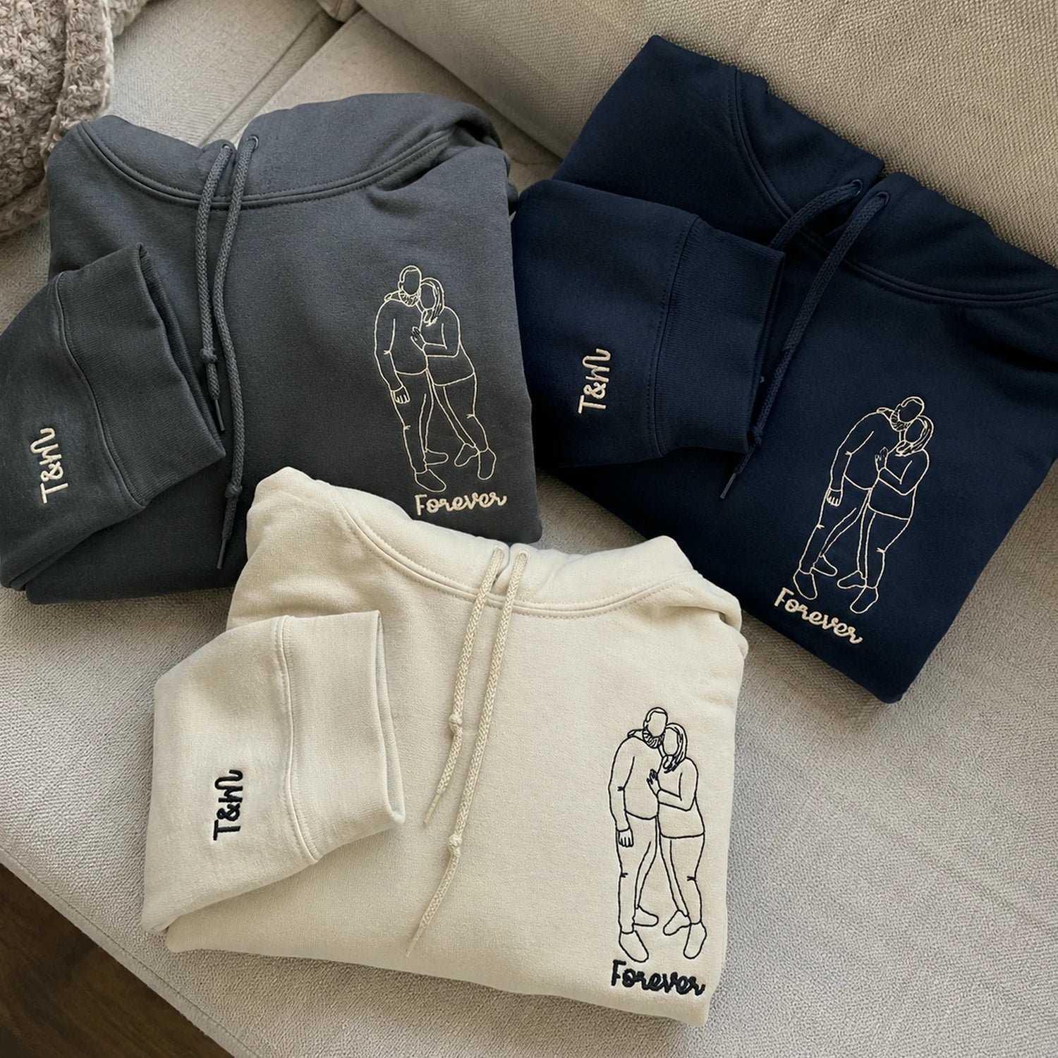 Three custom embroidered hoodies with couple portraits and initials