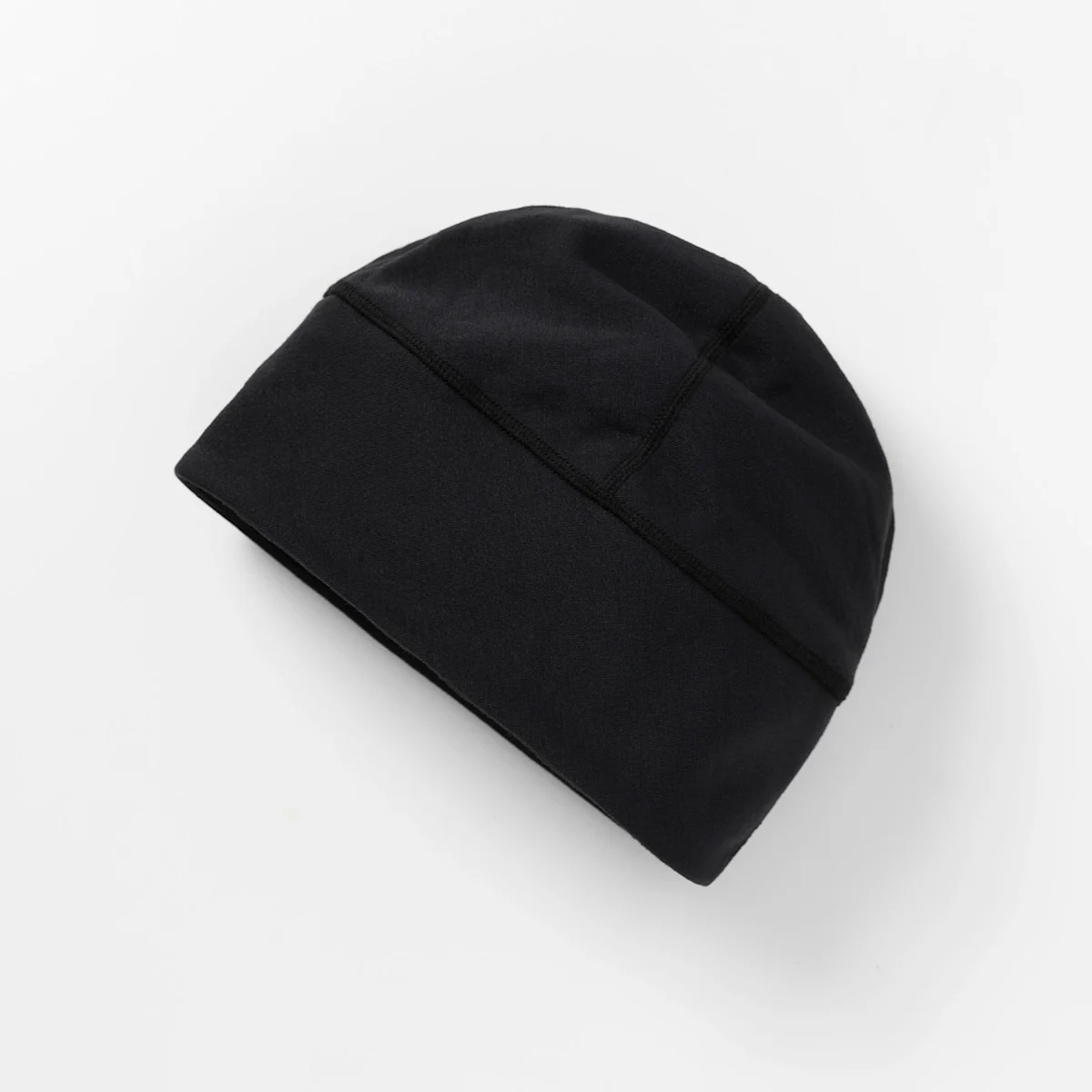 A plain black beanie hat on a white background