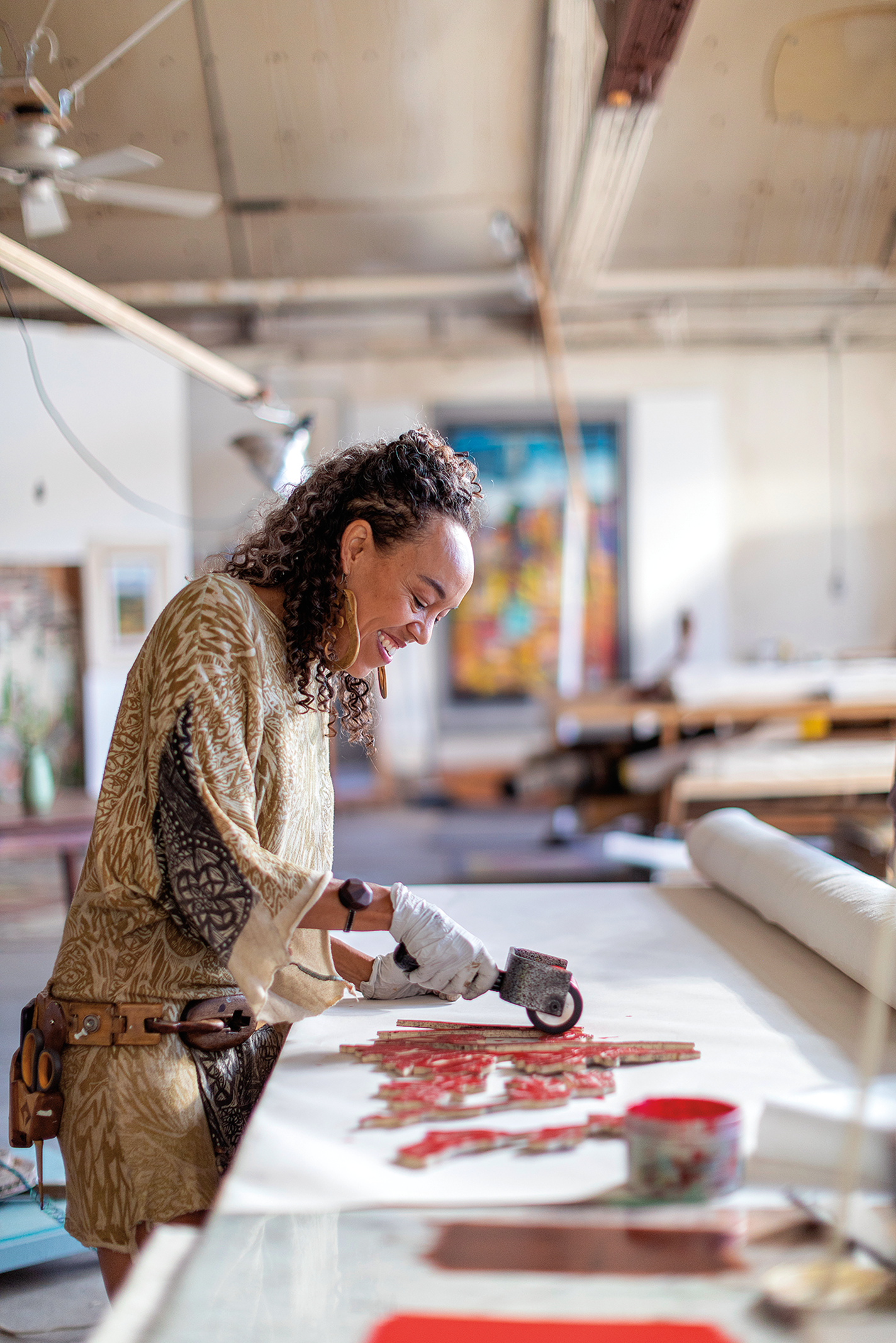 Woman printing a pattern onto fabric in a studio